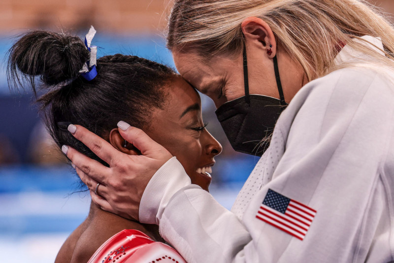 Tokyo, Japan, Tuesday, August 3, 2021 - USA gymnast Simone Biles is congratulated by her coach Cecile Landi as it becomes evident she will earn a medal in the Women’s Balance Beam Final at Ariake Gymnastics Centre. (Robert Gauthier/Los Angeles Times)